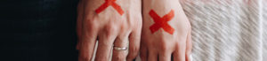 Couple with x's on their hands to represent infidelity
