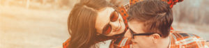 two people with sun glasses hugging